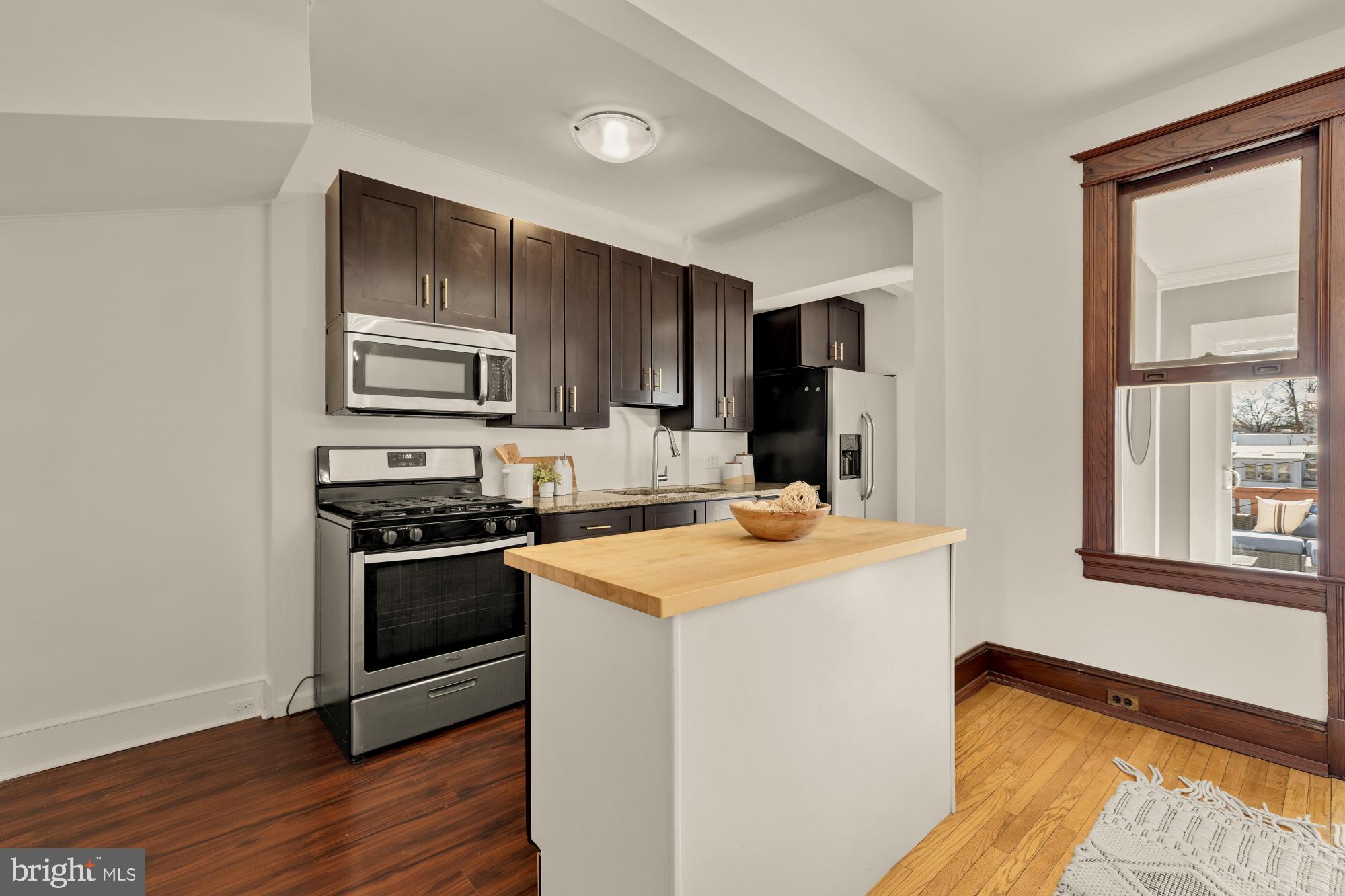 720 Webster Street Northwest Washington, DC 20011 - Photo 13 of 51 a kitchen with stainless steel appliances granite countertop a stove a sink and a refrigerator