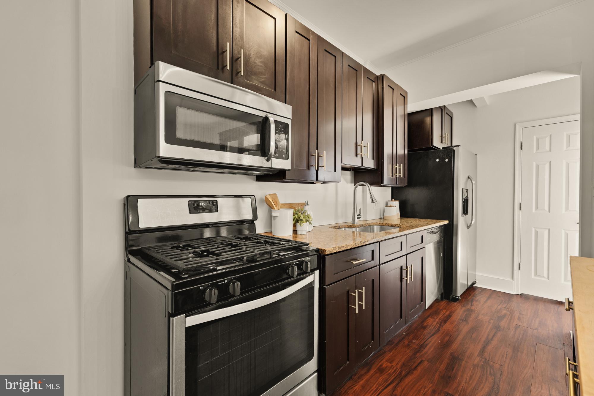 720 Webster Street Northwest Washington, DC 20011 - Photo 14 of 51 a kitchen with stainless steel appliances a stove a microwave and cabinets