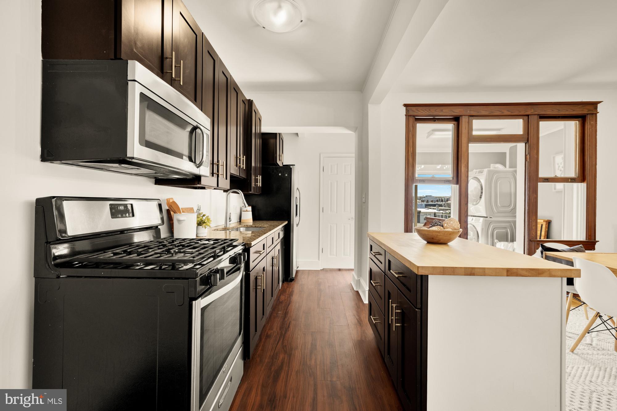 720 Webster Street Northwest Washington, DC 20011 - Photo 15 of 51 a kitchen with stainless steel appliances granite countertop a stove a sink and a microwave