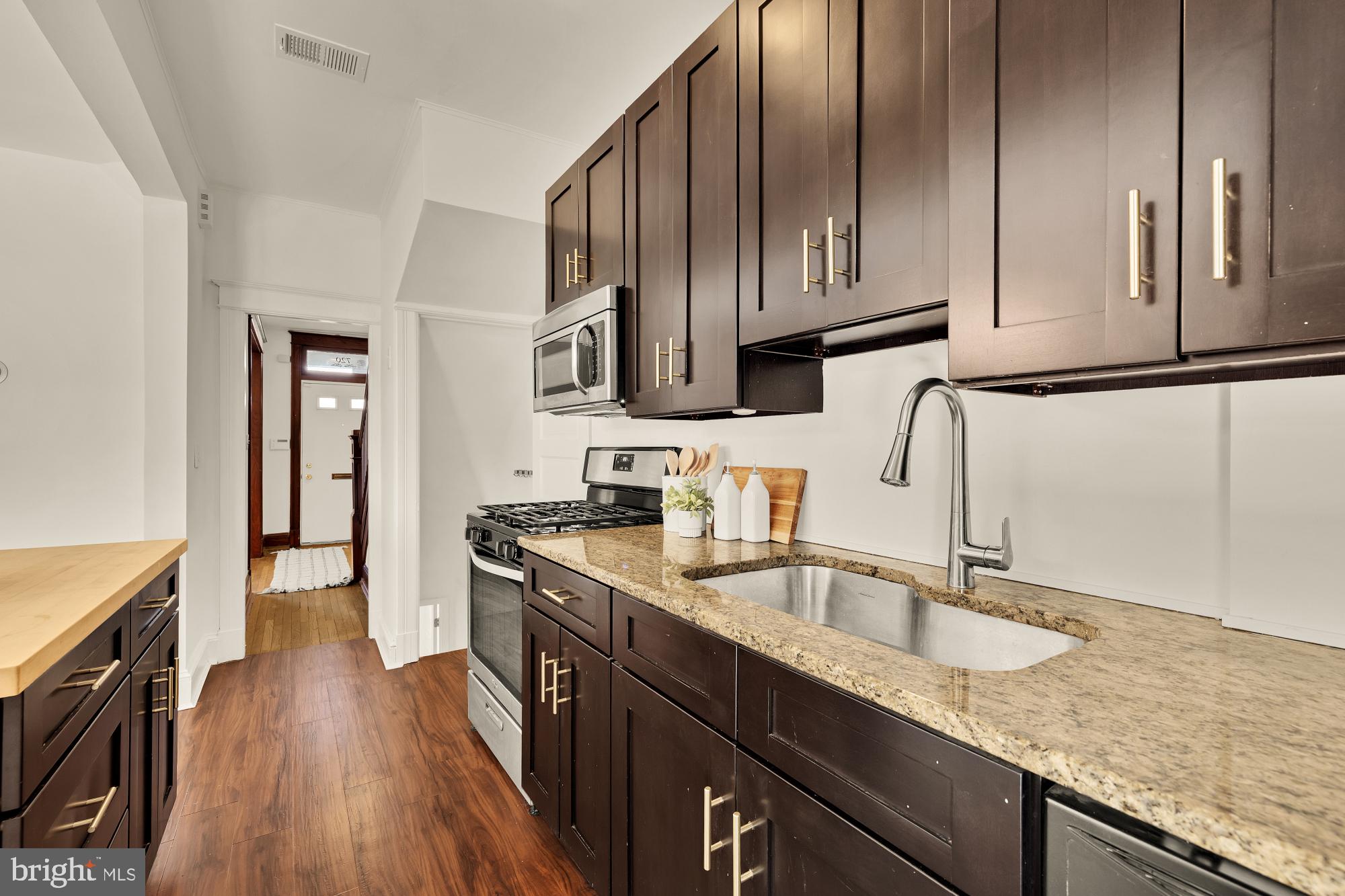 720 Webster Street Northwest Washington, DC 20011 - Photo 16 of 51 a kitchen with stainless steel appliances granite countertop a sink stove and cabinets