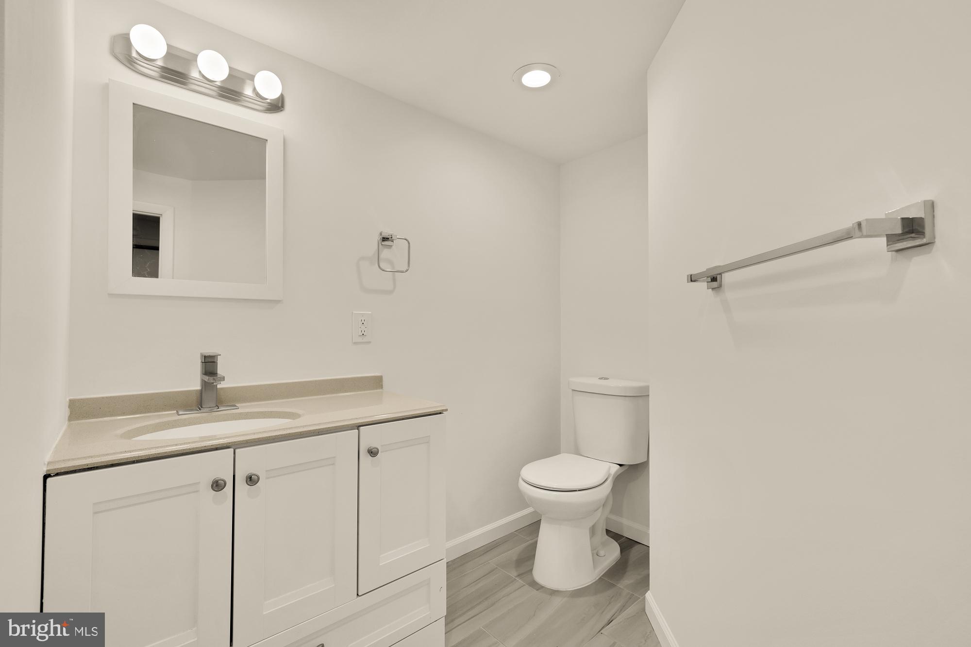 720 Webster Street Northwest Washington, DC 20011 - Photo 34 of 51 a bathroom with a granite countertop sink a toilet and a mirror