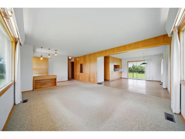 a view of a house with a big yard and potted plants