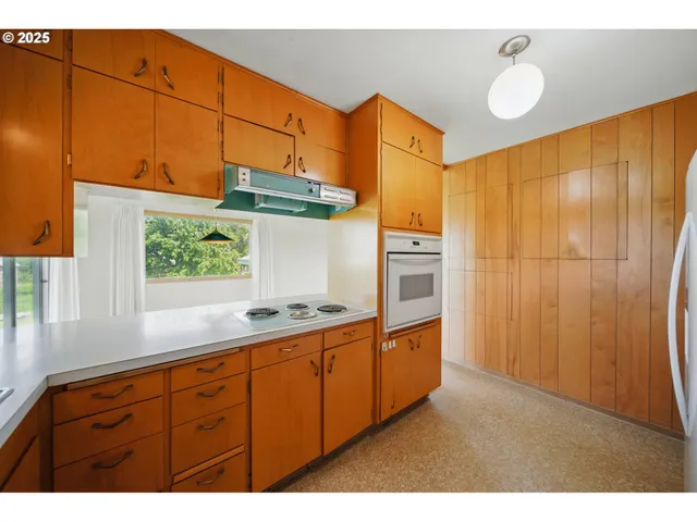 a kitchen with stainless steel appliances granite countertop a refrigerator a sink dishwasher and wooden cabinets
