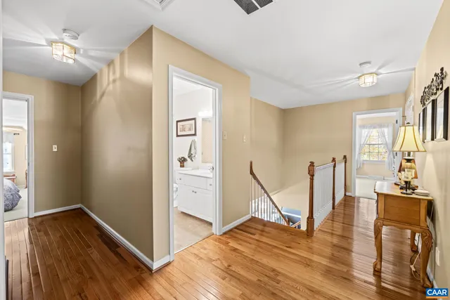 a bedroom with a bed couch and a view of living room