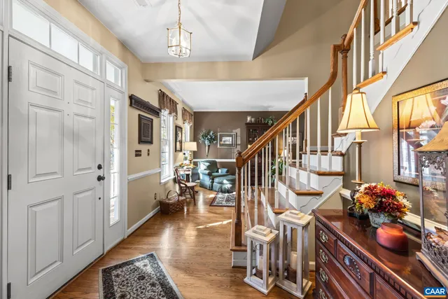 a view of entryway and hall with wooden floor