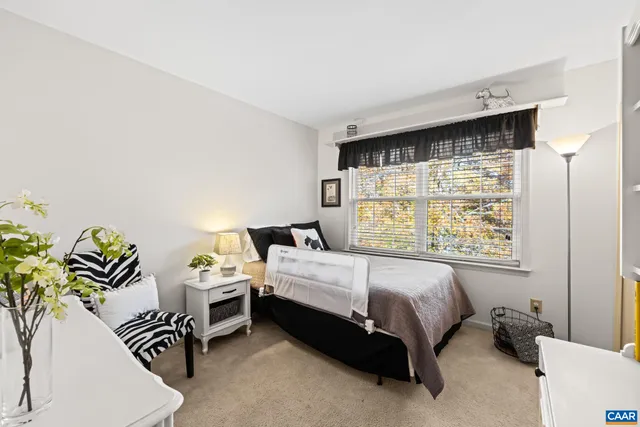 a bedroom with a bed furniture and a window