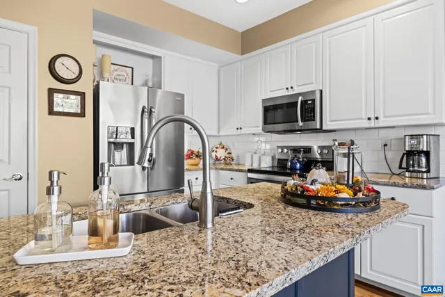 a kitchen with a stove a microwave and cabinets