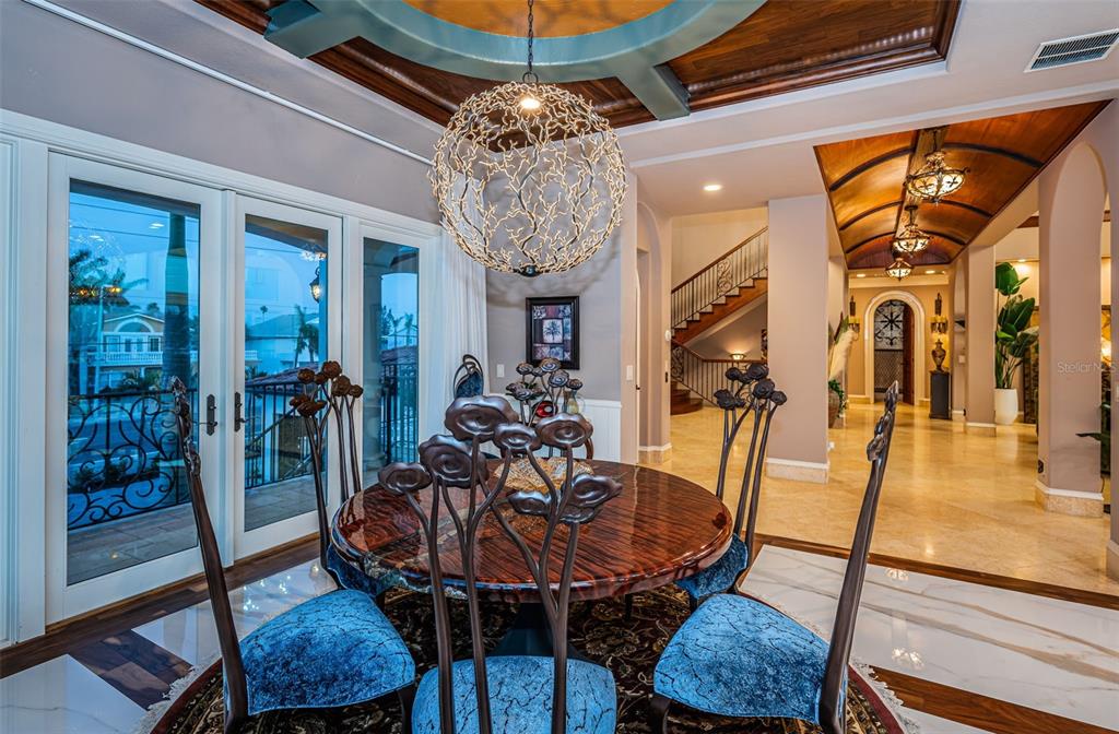 15912 Gulf Boulevard Redington Beach, FL 33708 - Photo 21 of 100 a view of a dining room with furniture wooden floor and chandelier