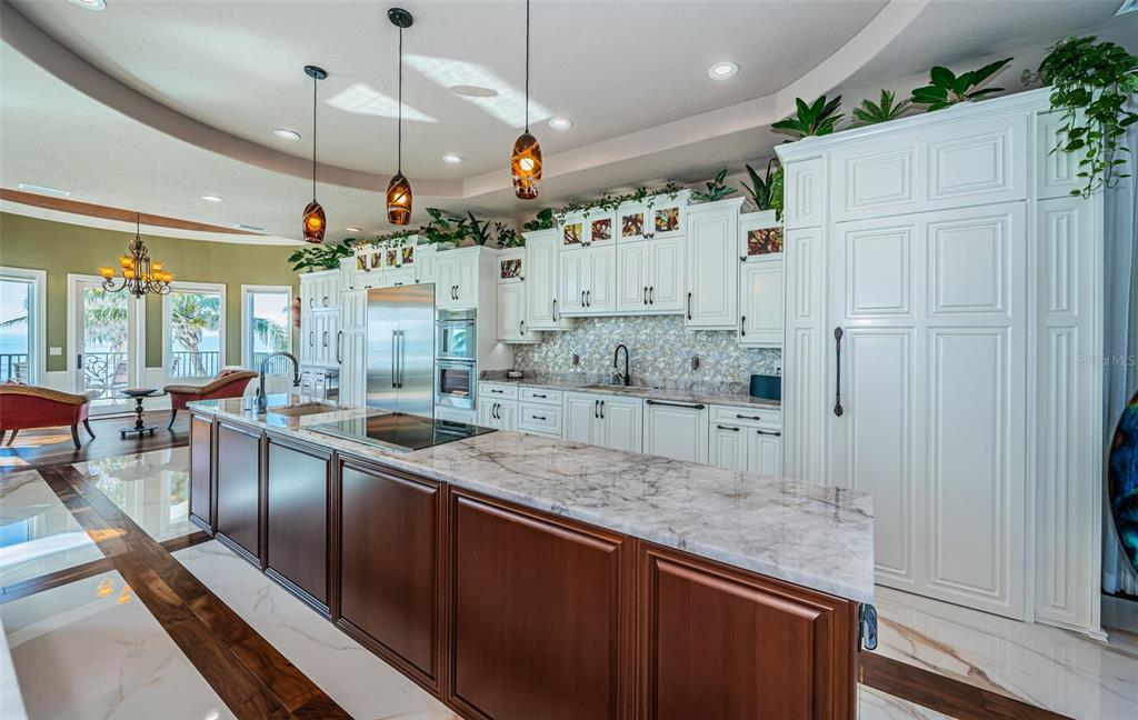 15912 Gulf Boulevard Redington Beach, FL 33708 - Photo 26 of 100 a large kitchen with lots of counter space and wooden floor