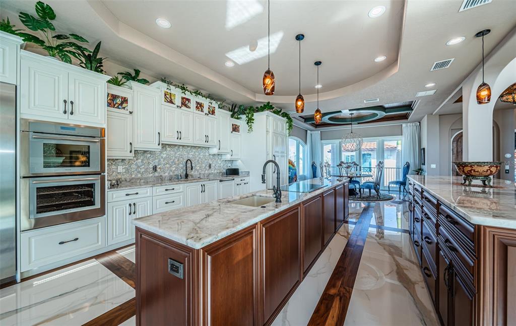 15912 Gulf Boulevard Redington Beach, FL 33708 - Photo 33 of 100 a kitchen with stainless steel appliances granite countertop a kitchen island a stove and a sink
