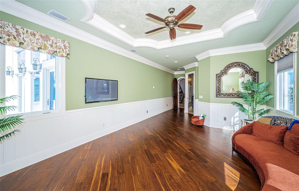 15912 Gulf Boulevard Redington Beach, FL 33708 - Photo 51 of 100 a view of a livingroom with furniture a ceiling fan and wooden floor