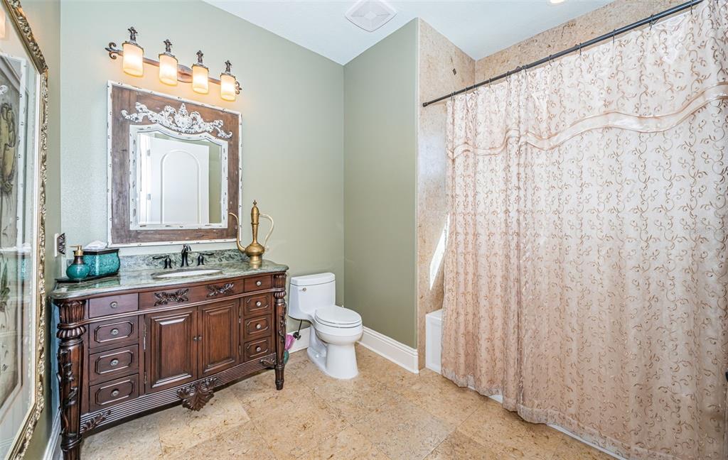 15912 Gulf Boulevard Redington Beach, FL 33708 - Photo 52 of 100 a bathroom with a toilet a sink and a mirror