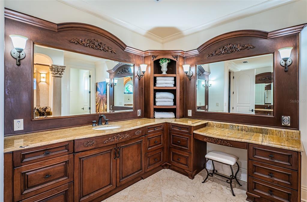 15912 Gulf Boulevard Redington Beach, FL 33708 - Photo 69 of 100 a spacious bathroom with a granite countertop sink and a large mirror