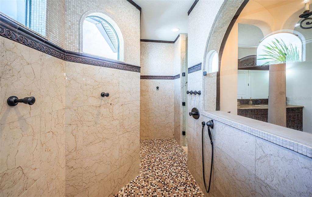 15912 Gulf Boulevard Redington Beach, FL 33708 - Photo 73 of 100 a bathroom with a sink a mirror and a shower