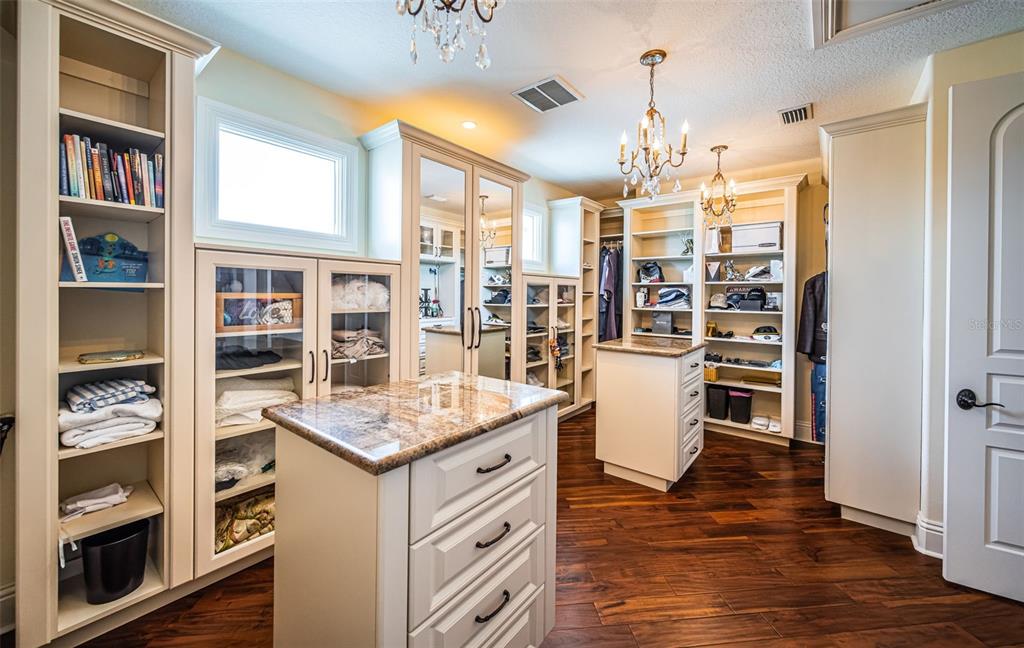 15912 Gulf Boulevard Redington Beach, FL 33708 - Photo 75 of 100 a kitchen that has a lot of cabinets and wooden floor
