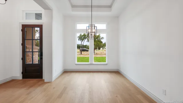 en empty room with windows and entrance