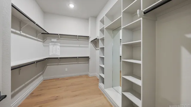 a view of walk in closet with empty racks