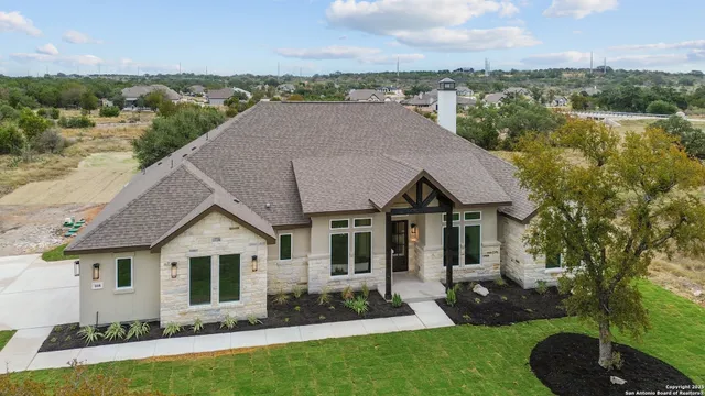 an aerial view of a house with a yard