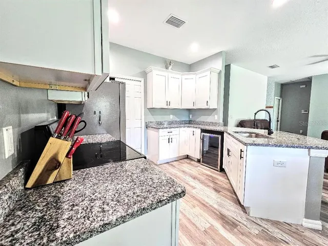 a kitchen with a sink stove and cabinets
