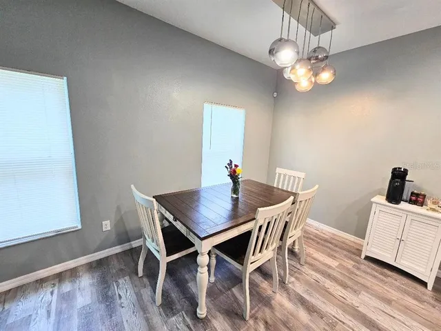 a view of a dining room with a table and chairs