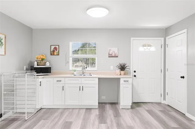 a spacious bathroom with stainless steel appliances a sink and a window