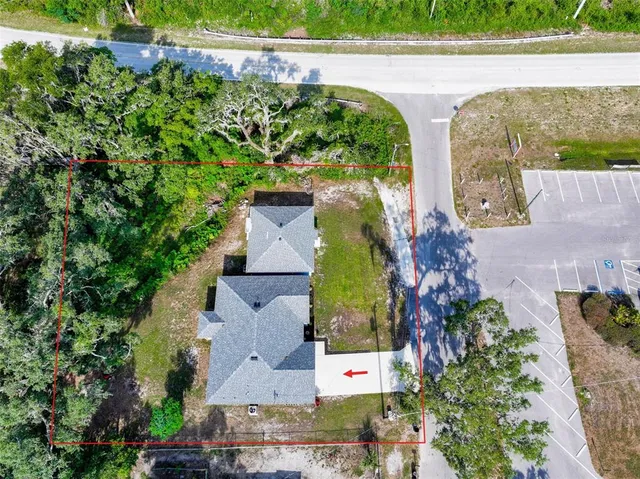 an aerial view of a house with a yard and potted plants