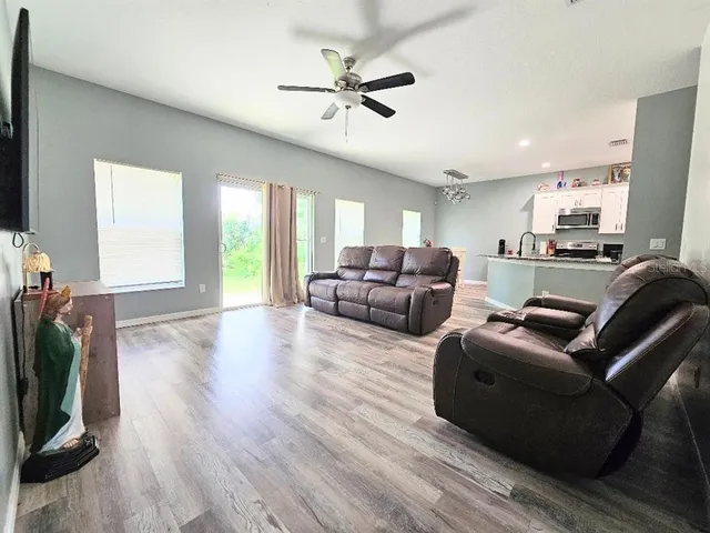 a living room with furniture window and a flat screen tv