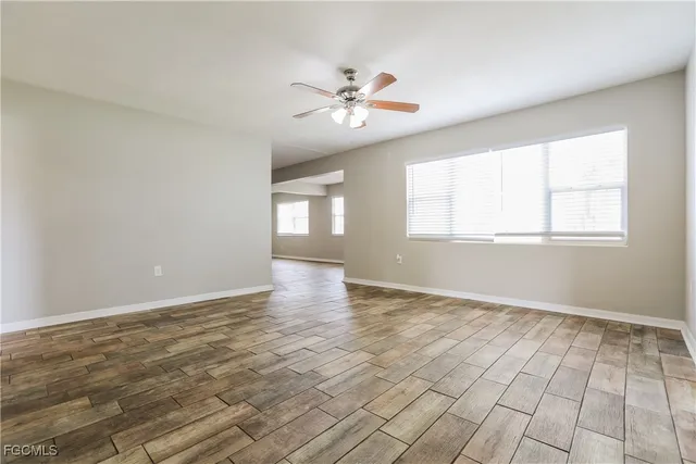 wooden floor in an empty room with a window