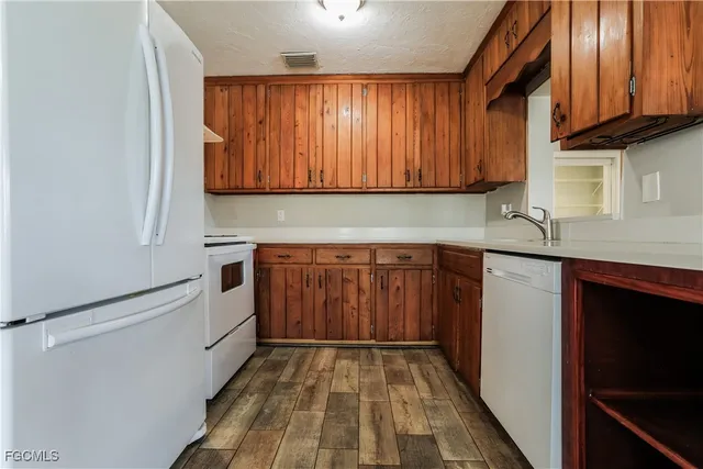a kitchen with a sink cabinets and appliances