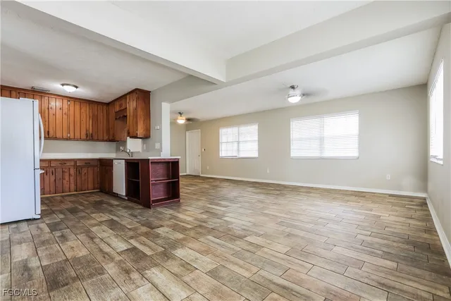 a view of kitchen with stainless steel appliances cabinets and wooden floor