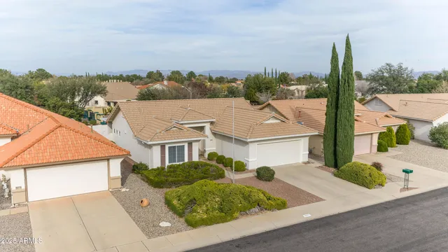 aerial view of a house with a yard and balcony