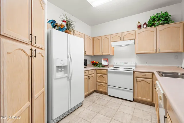 a kitchen with white cabinets and white appliances