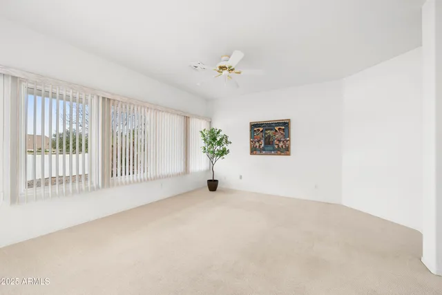 a view of a livingroom with furniture and a chandelier fan