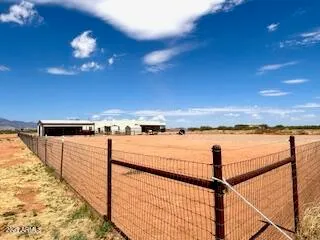 a living room with furniture a fireplace and large windows