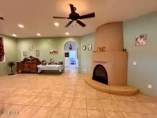 a living room with furniture a flat screen tv and a window