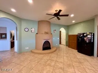 a view of a hallway with wooden floor and a living room