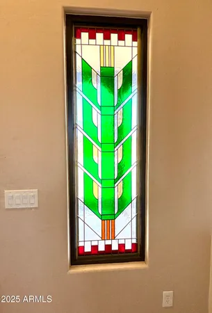 a living room with a bed furniture and a flat screen tv