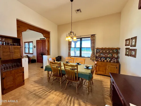 a white toilet sitting next to a white wall