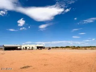 a kitchen with stainless steel appliances kitchen island granite countertop a sink counter and chairs