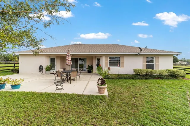 a view of a backyard with a garden and entertaining space