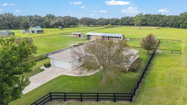 a view of a lake with a yard and large trees