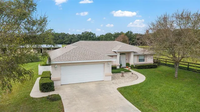 an aerial view of a house with a garden and swimming pool