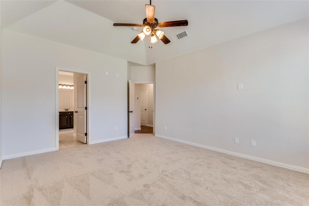 2344 Ranchview Drive Little Elm, TX 75068 - Photo 12 of 24 Spacious room featuring vaulted ceiling, carpet flooring, and a ceiling fan with light fixture