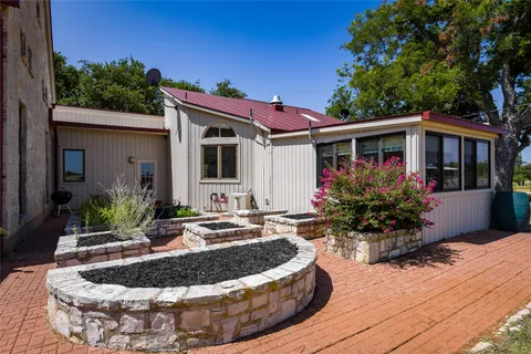a view of a house with sitting area and garden