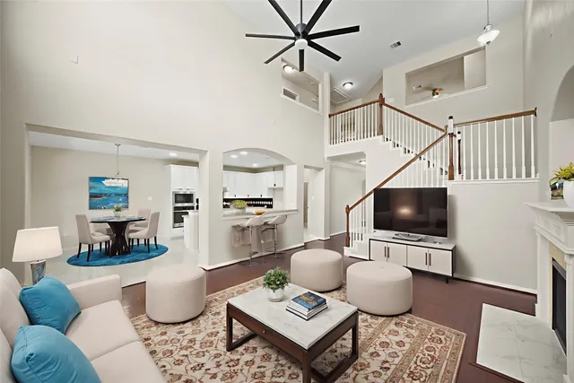 a living room with furniture a rug and a flat screen tv