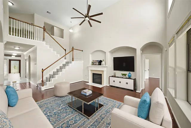 a living room with furniture a flat screen tv and a fireplace
