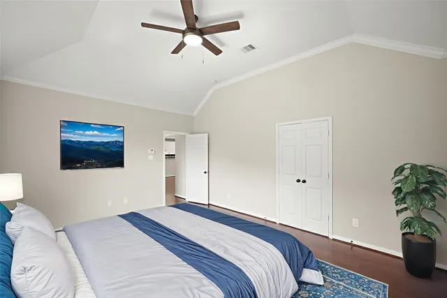 a bedroom with a bed and a potted plant