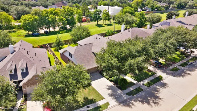 an aerial view of a house with a yard and lake view