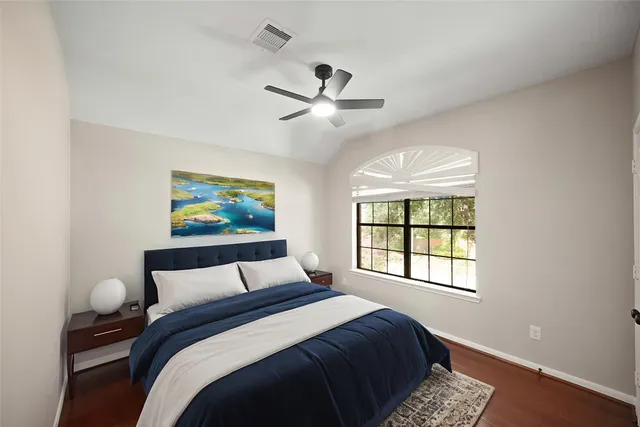 a bedroom with a large bed and a window