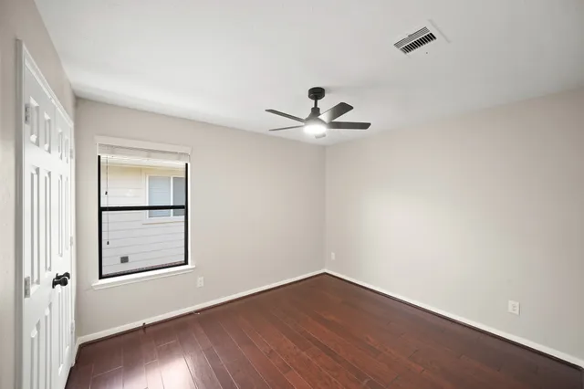 a view of a room with wooden floor and closet